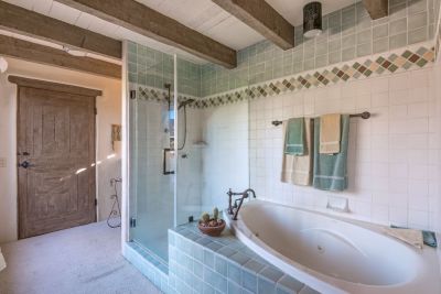 Master bathroom features a glass shower and soaking tub