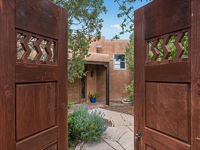 Wooden doors open to Entry Courtyard