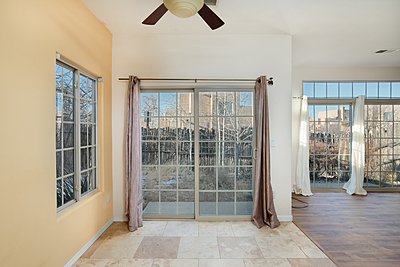 Sliding glass doors in dining area open to small patio