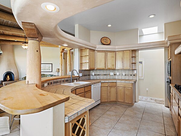 Curved Kitchen with Ample Storage and Countertop Area